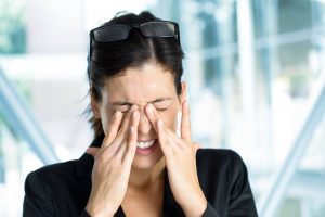 Woman rubbing dry eyes